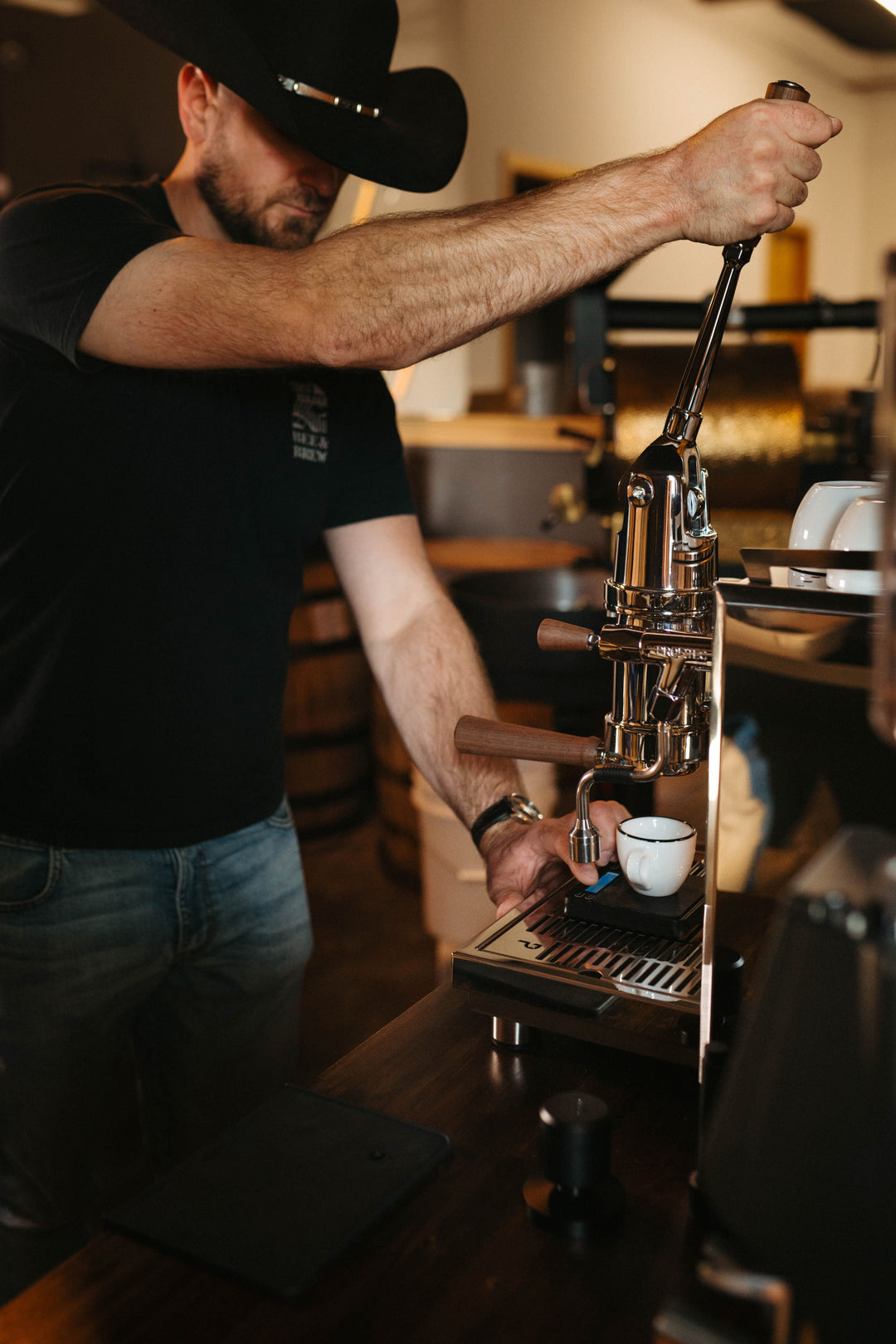 Chris pulling the lever on a Profitec Pro 800 espresso machine at Bee & Brew in Fort Worth, Texas.